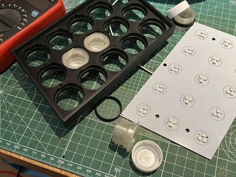 Bottle-cap holders and the LED board during assembly