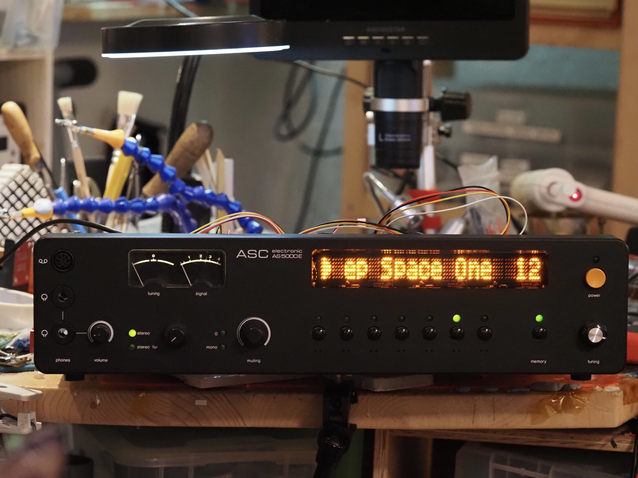 The ASC AS-5000E front panel showing station information on its amber matrix display